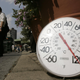 A thermometer in the sun on the sidewalk indicates a temperature of 120 degrees Fahrenheit as people eat ice cream on the Upper West Side August 2, 2006